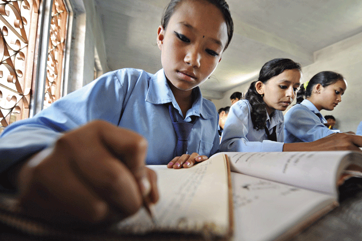 Figure 2.1 Schoolgirls in Nepal in deep concentration