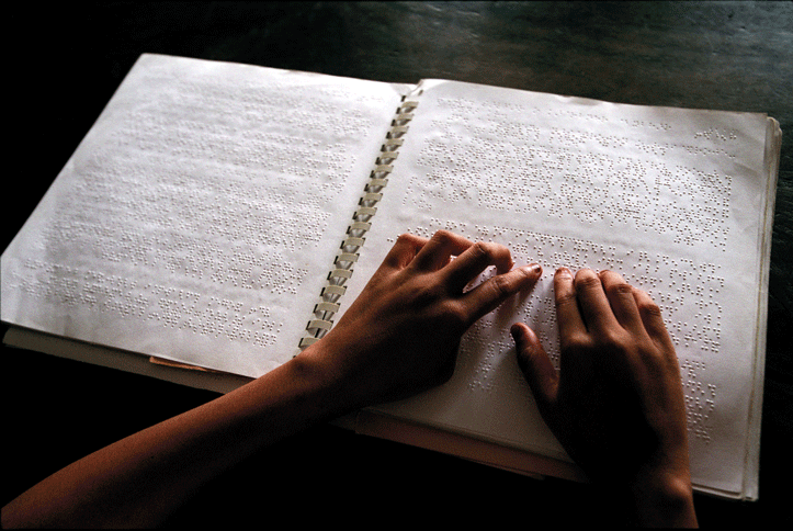 Figure 3.2 A blind child reading at a school in Bangladesh