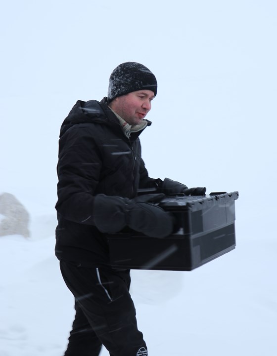 Minister of Agriculture and Food Mr Pollestad carries in a box of Norwegian forest seed to be deposited in the Svalbard Global Seed Vault.