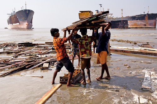 Figure 9.2 Young boys and men working as shipbreakers on a beach in Bangladesh.