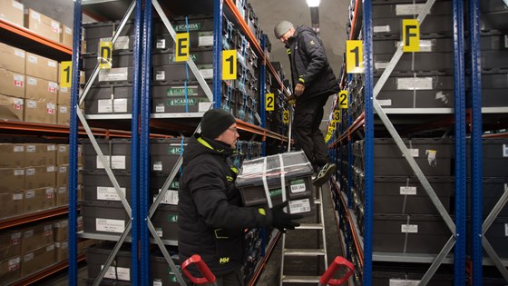 NordGen staff, Fredrik Kollberg (left) and Åsmund Asdal bring new seed boxes in to final position in the Vault shelves