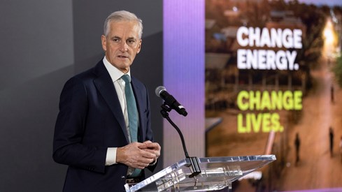 The Prime Minister behind a speech stand on stage.